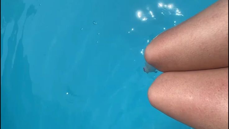 Playing with my feet in water at the pool